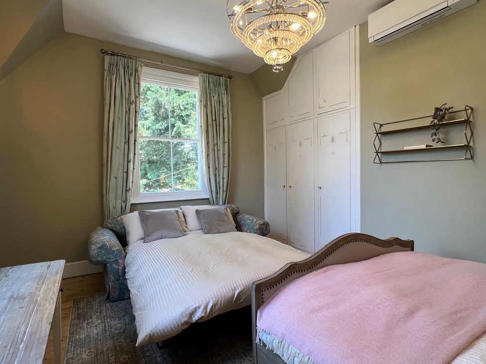 A bedroom with a sofa and bed at Your Country House in Reading