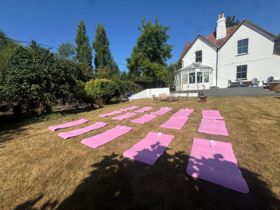 A garden with yoga mats laid out at Your Country House in Reading
