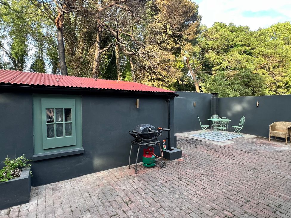 An outdoor patio with a grill and seating at Your Country House in Reading