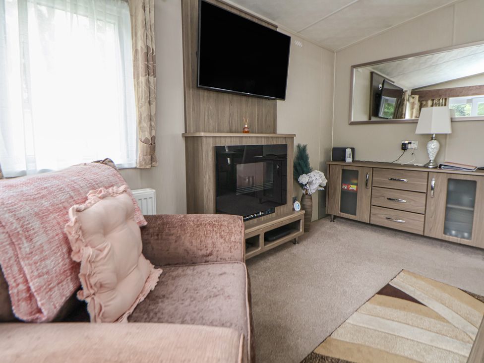 A living room with a sofa and television at Delta Superior
