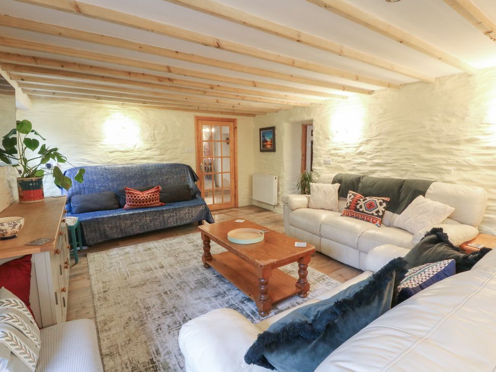 A living room with seating arrangements at Penally Mews in St Dogmaels