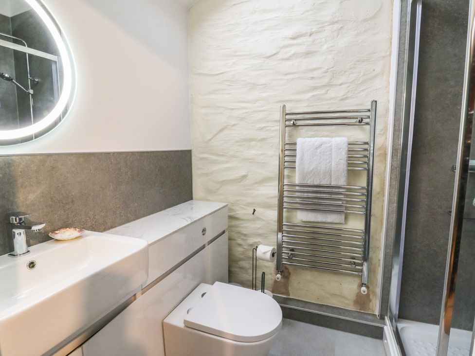 A bathroom with a sink and toilet at Penally Mews in St Dogmaels