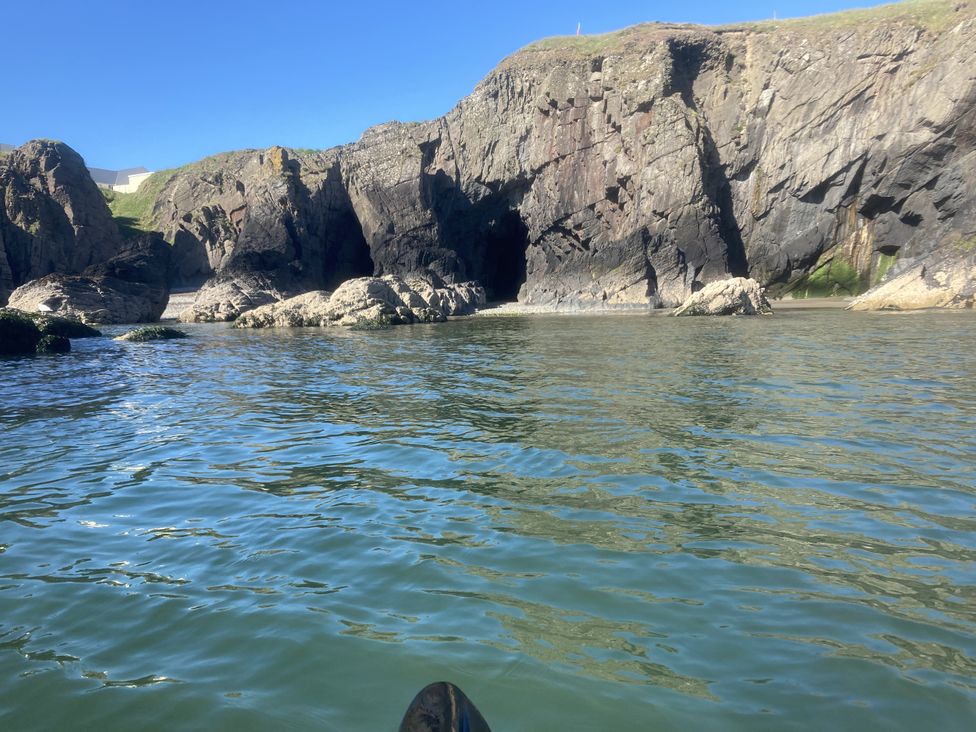 A scenic view of rock formations and water at Penally Mews in St Dogmaels