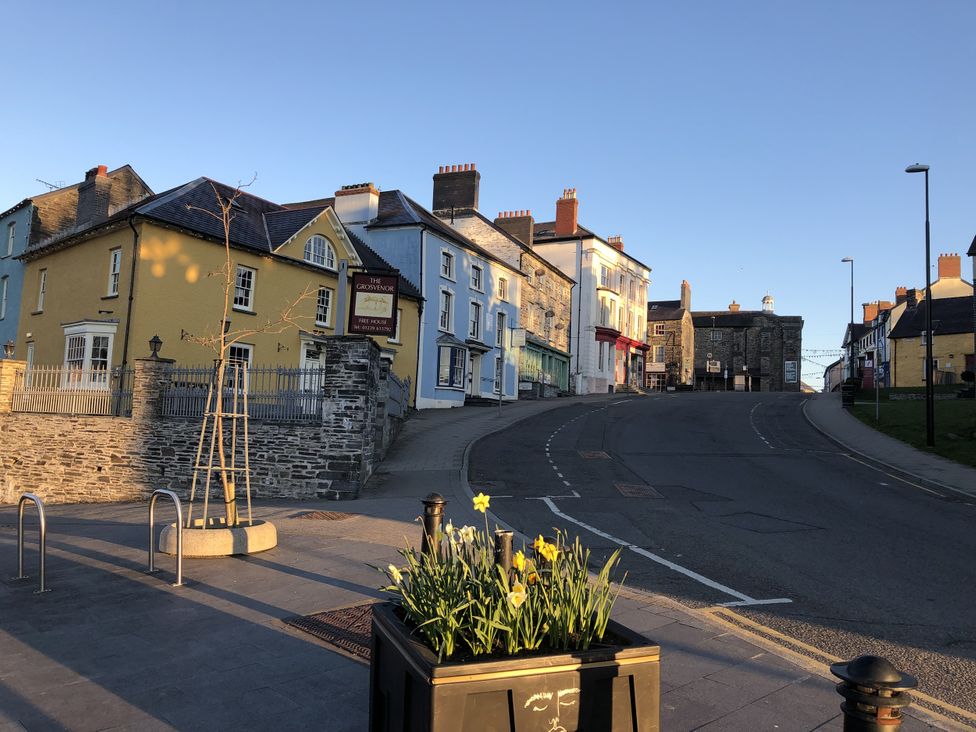 A street view with buildings and flower planter at Penally Mews St Dogmaels