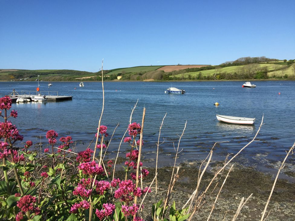 A view of the water with boats and flowers at Penally Mews in St Dogmaels