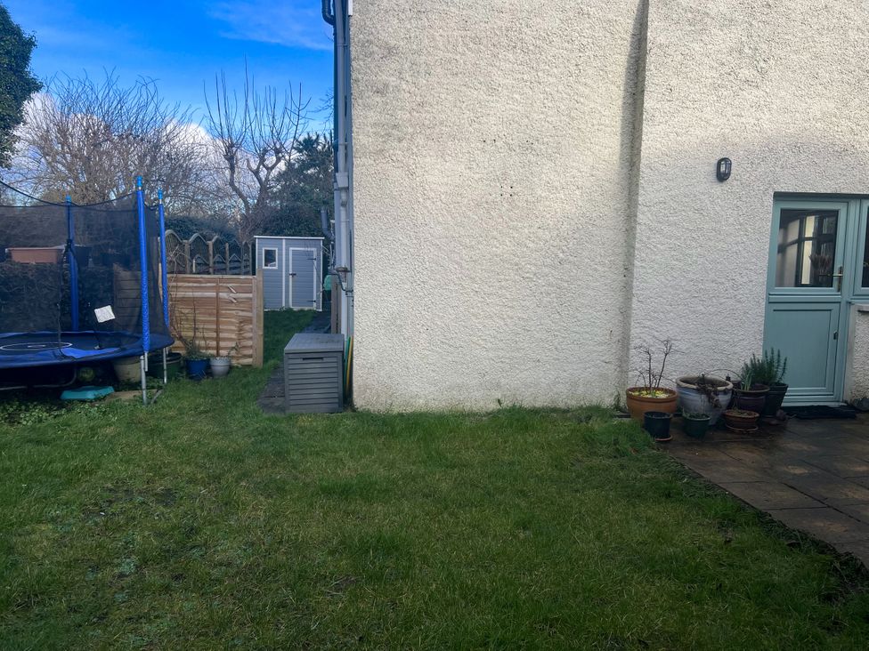 A garden with a trampoline and a shed at Penally Mews St Dogmaels