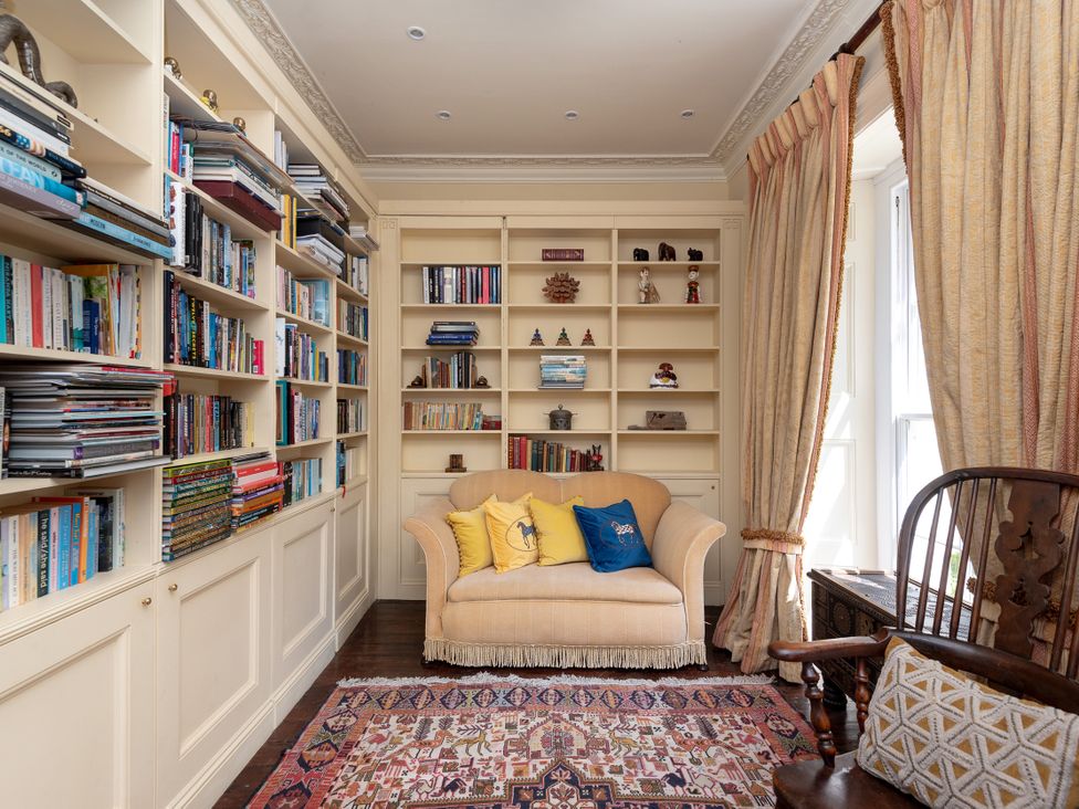 A study with a bookshelf and a sofa at The Old Vicarage in St Issey