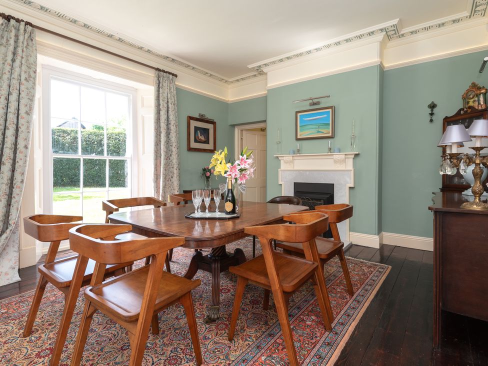 A dining room with a table and chairs at The Old Vicarage in St Issey
