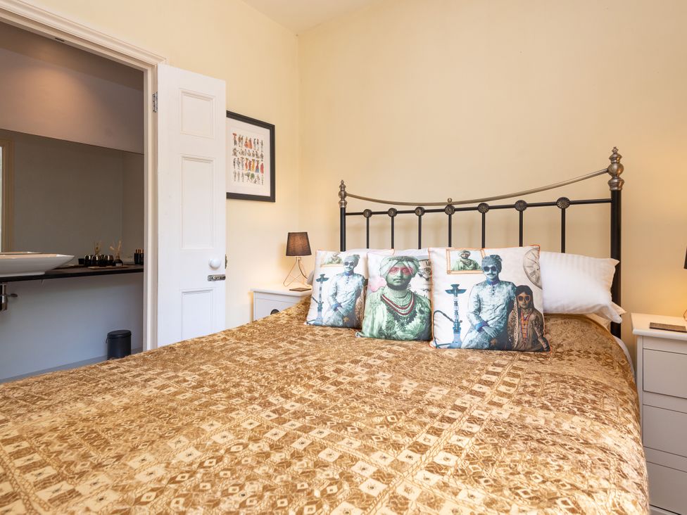 A bedroom with a bed and wall art at The Old Vicarage in St Issey