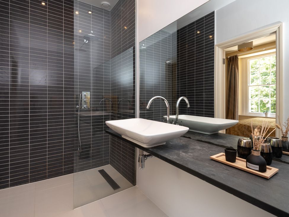 A bathroom with a shower and sink at The Old Vicarage in St Issey