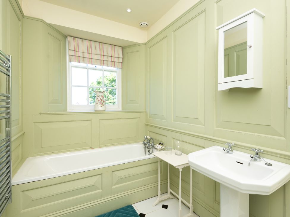 A bathroom with a bathtub and sink at The Old Vicarage St Issey