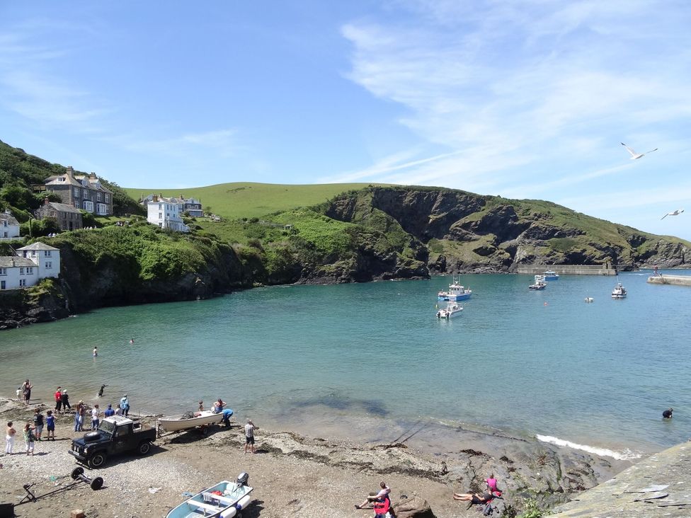 A beach scene with boats and people at The Old Vicarage St Issey