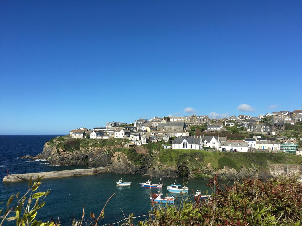 A seaside view with boats in a harbor at The Old Vicarage in St Issey