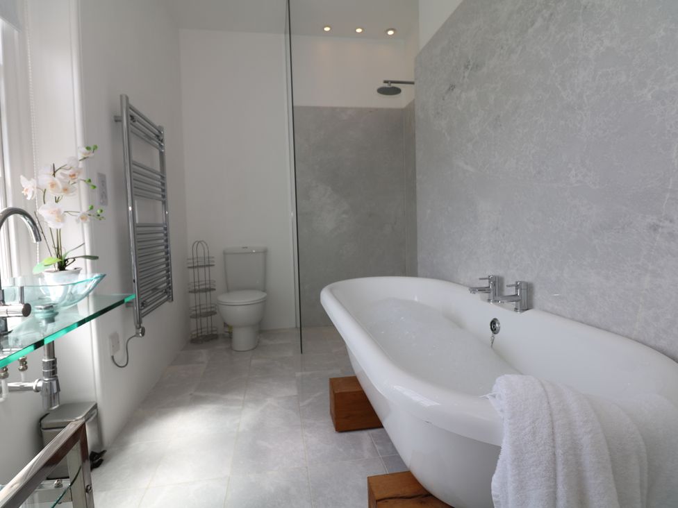 A bathroom with a bathtub and shower at The Old Vicarage in St Issey