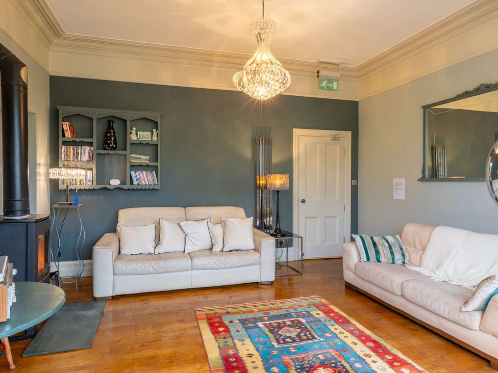 A living room with sofas and a fireplace at The Boundary in Windermere