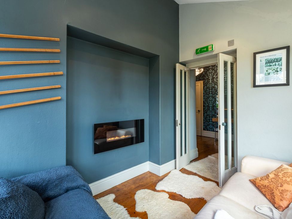 A living room featuring a fireplace and a sofa at The Boundary in Windermere