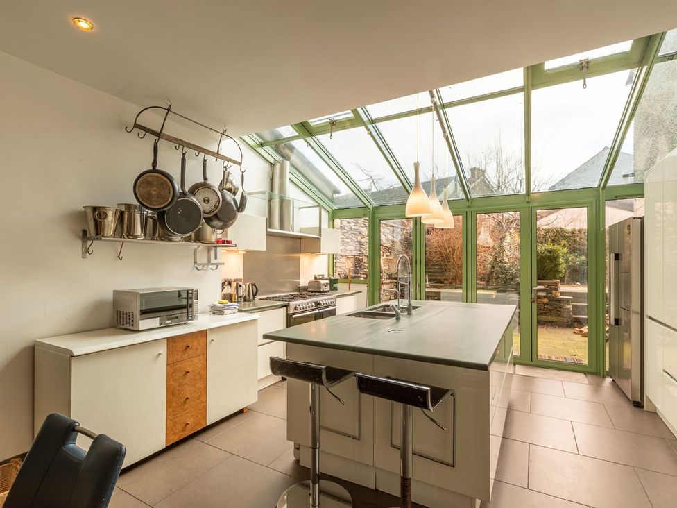 A kitchen with an island and cooking equipment at The Boundary in Windermere