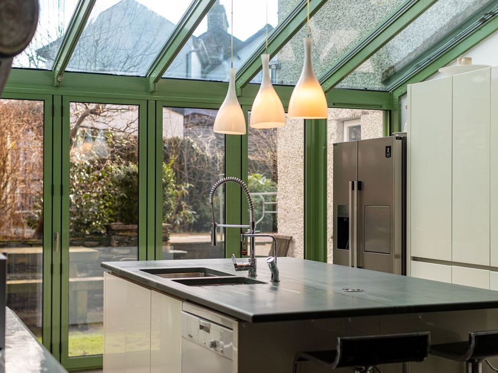 A kitchen with a sink and refrigerator at The Boundary in Windermere