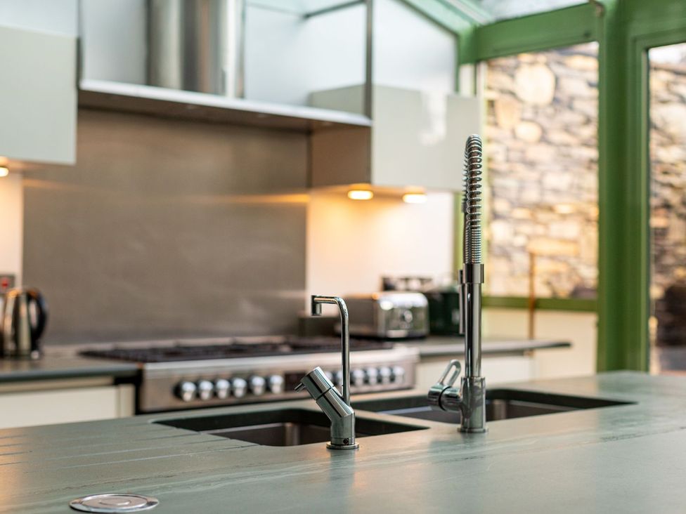 A kitchen with a sink and stove at The Boundary in Windermere