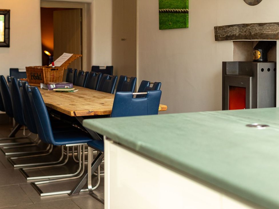 A dining room with a long table and chairs at The Boundary in Windermere