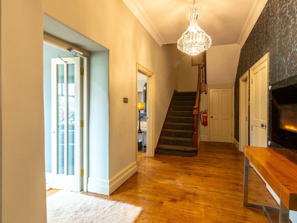 A hallway with a front door and staircase at The Boundary in Windermere