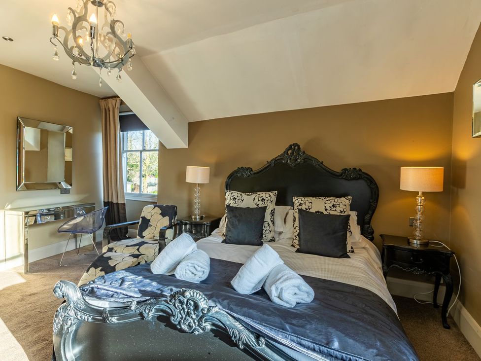 A bedroom with a bed and mirror at The Boundary in Windermere