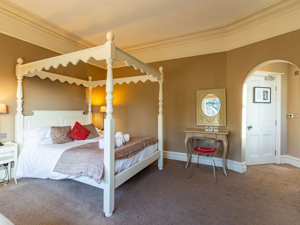 A bedroom with a four-poster bed and a desk at The Boundary in Windermere