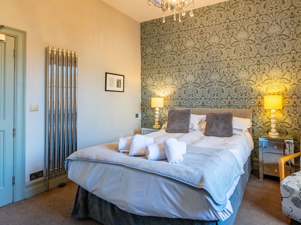 A bedroom with a bed and lamps at The Boundary in Windermere