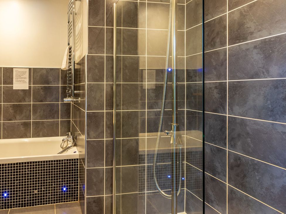 A bathroom with a shower and bathtub at The Boundary in Windermere