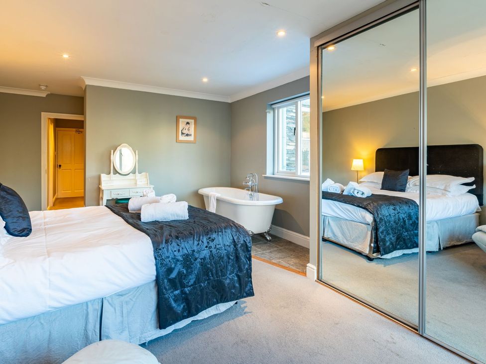 A bedroom with a bed and a bathtub at The Boundary in Windermere