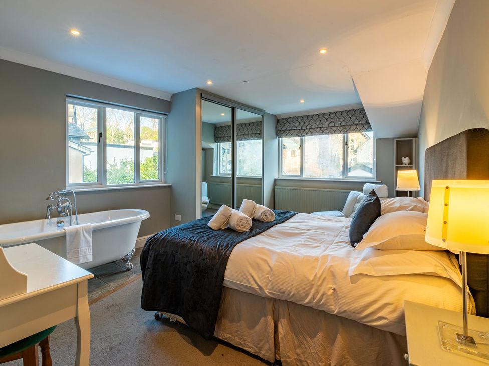 A bedroom with a bed and a bathtub at The Boundary in Windermere