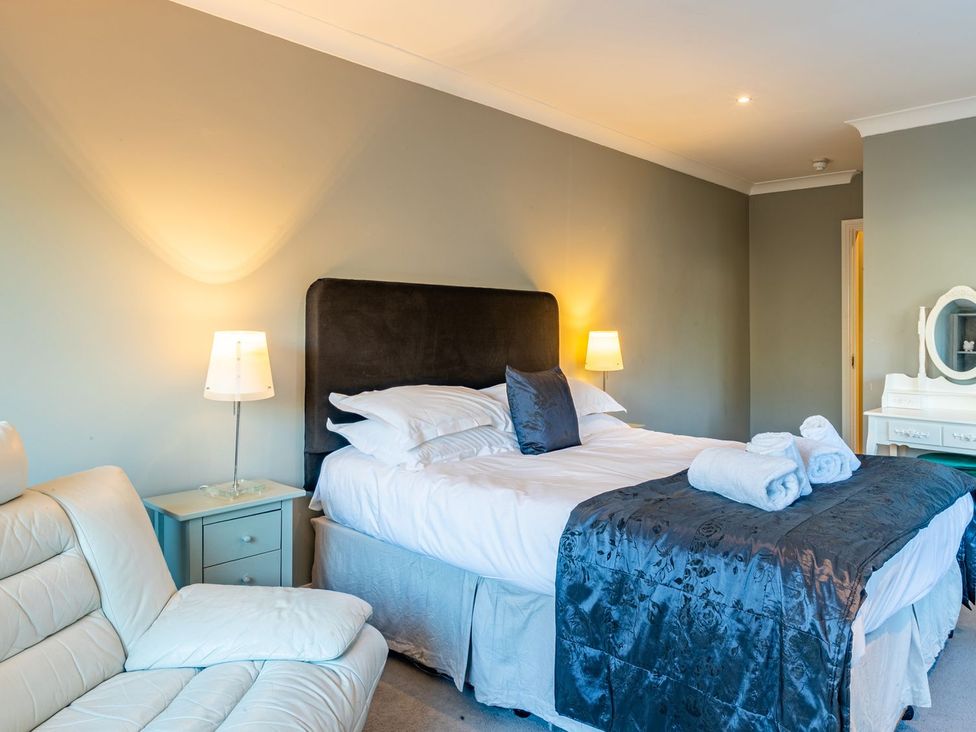 A bedroom with a bed and a sofa at The Boundary in Windermere
