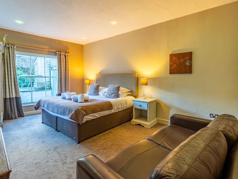 A bedroom with a bed and sofa at The Boundary in Windermere