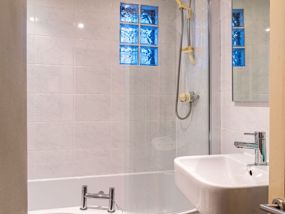A bathroom featuring a bathtub, shower, and sink at The Boundary in Windermere