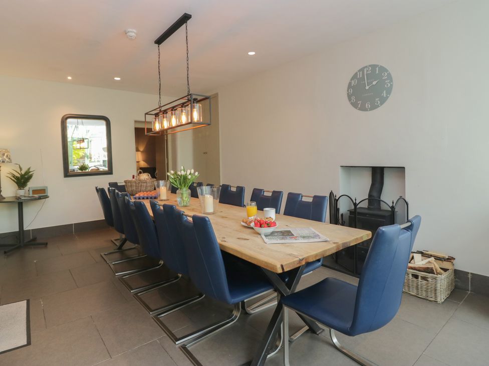 A dining room with a long table and chairs at The Boundary in Windermere