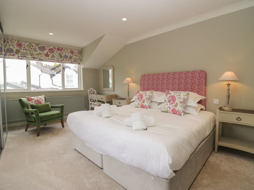 A bedroom with a bed and chair at The Boundary in Windermere
