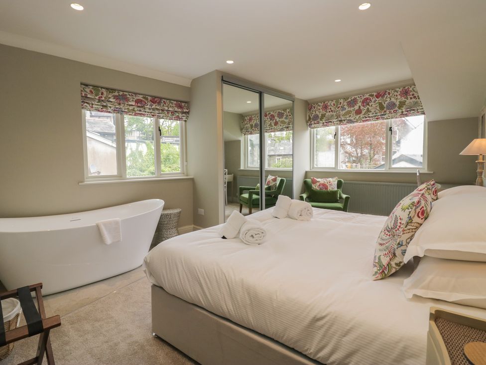 A bedroom with a bed and a bathtub at The Boundary in Windermere