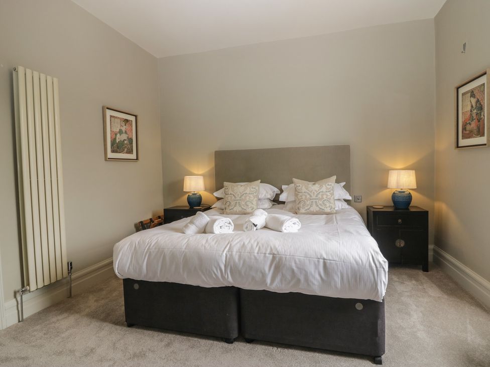 A bedroom with a bed and bedside tables at The Boundary in Windermere