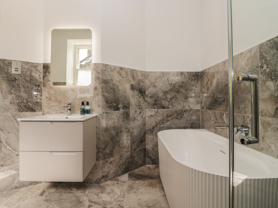 A bathroom with a bathtub and sink at The Boundary in Windermere