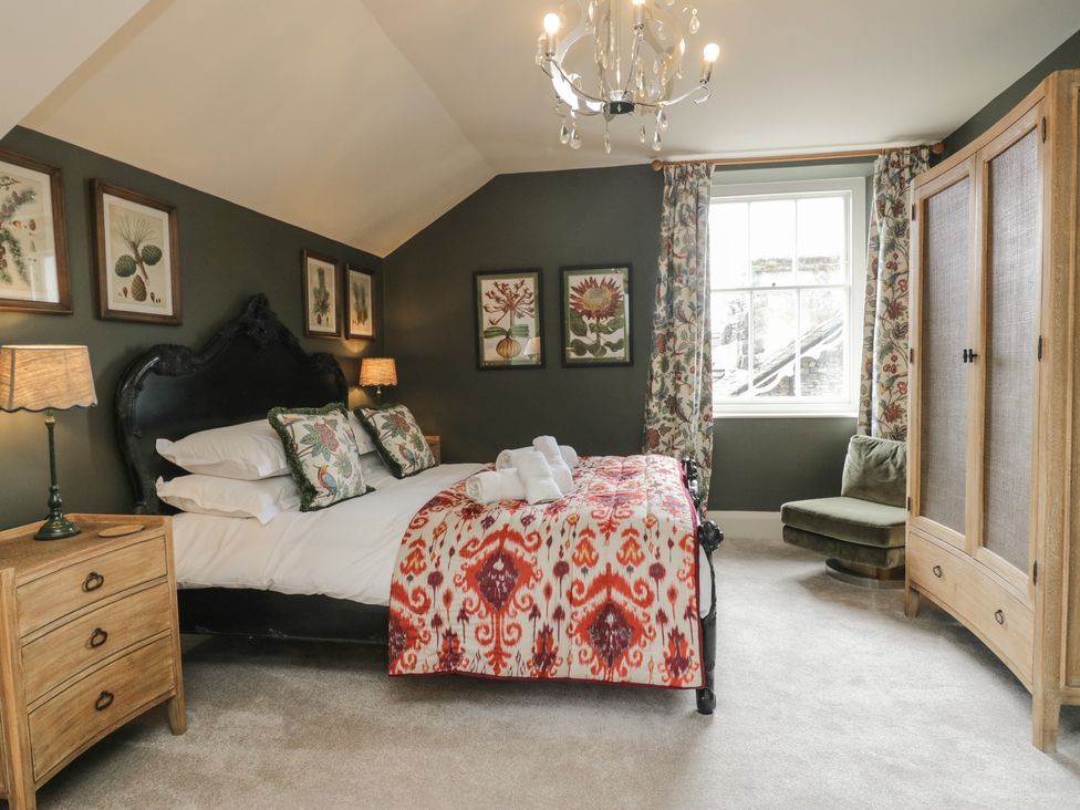 A bedroom with a bed, nightstand, and wardrobe at The Boundary in Windermere