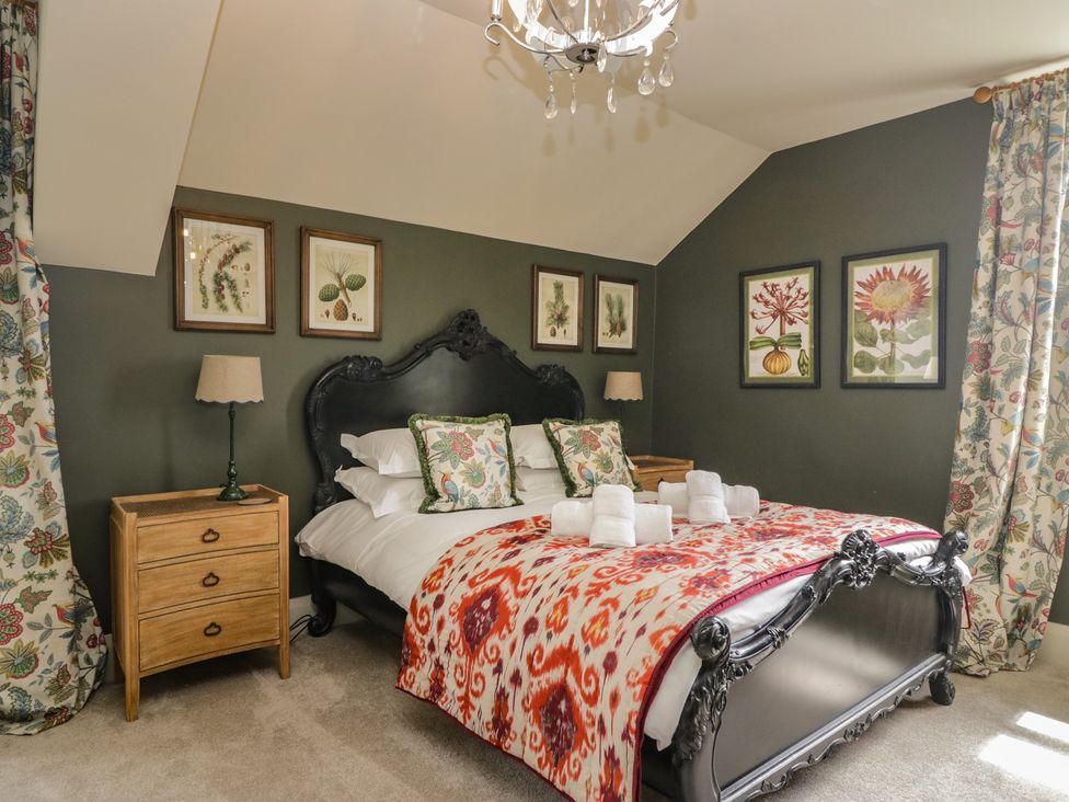 A bedroom with a bed and bedside tables at The Boundary in Windermere