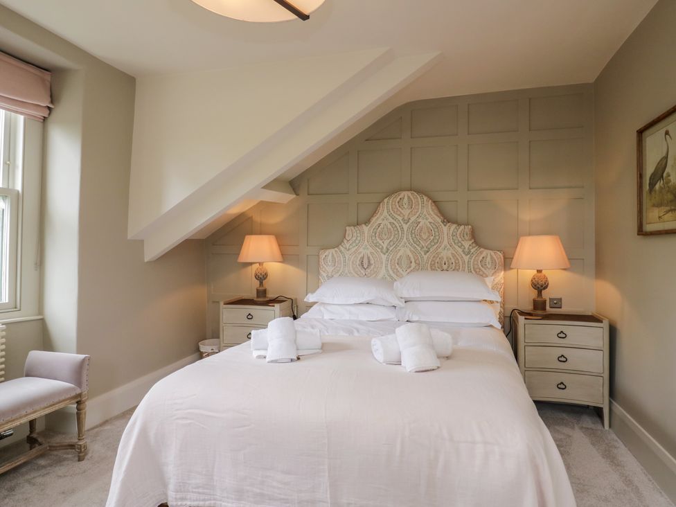 A bedroom with a bed, nightstand, and lamp at The Boundary in Windermere