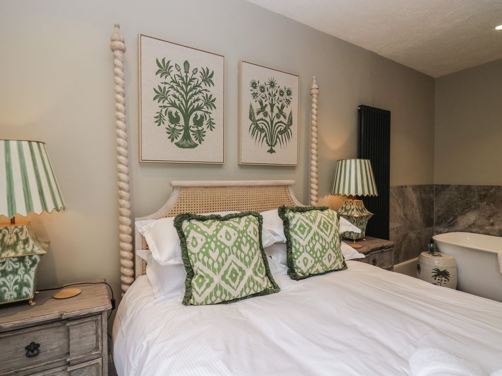 A bedroom with a bed and decorative pillows at The Boundary in Windermere