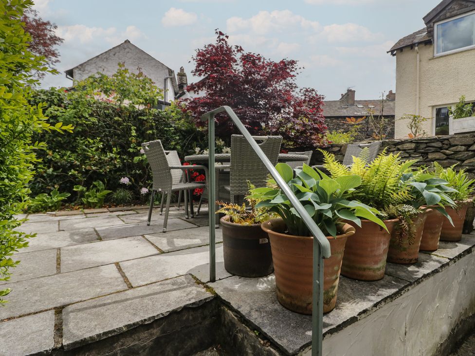 A garden with table and chairs and potted plants at The Boundary in Windermere