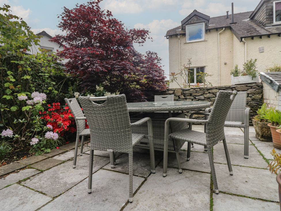 A garden with a table and chairs surrounded by plants at The Boundary in Windermere