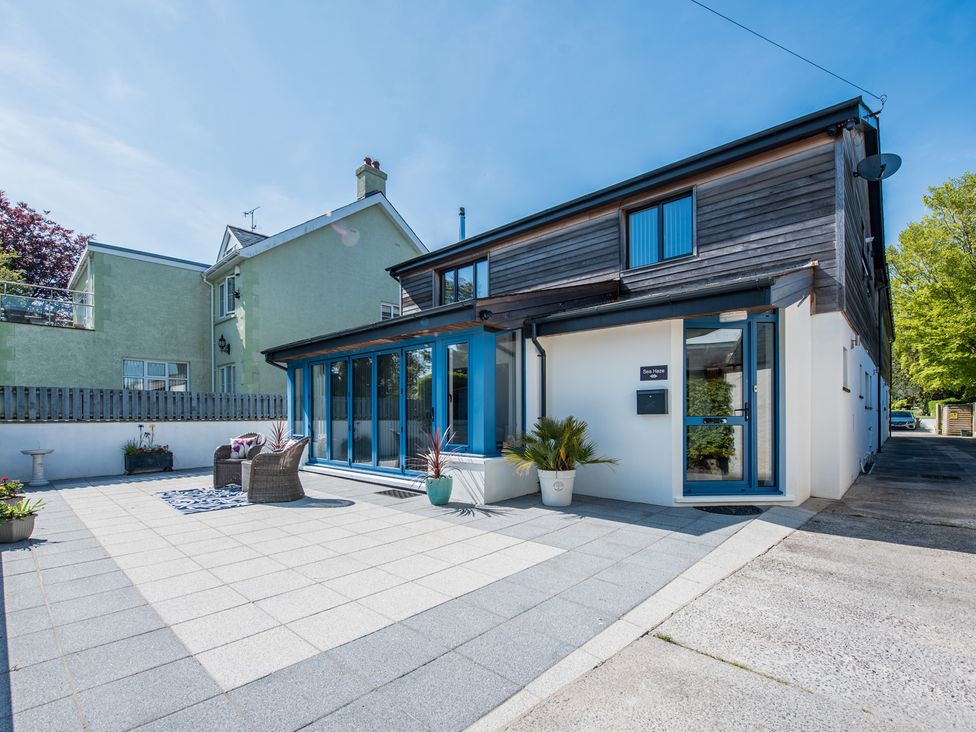 A house with patio and chairs at Sea Haze in Tenby