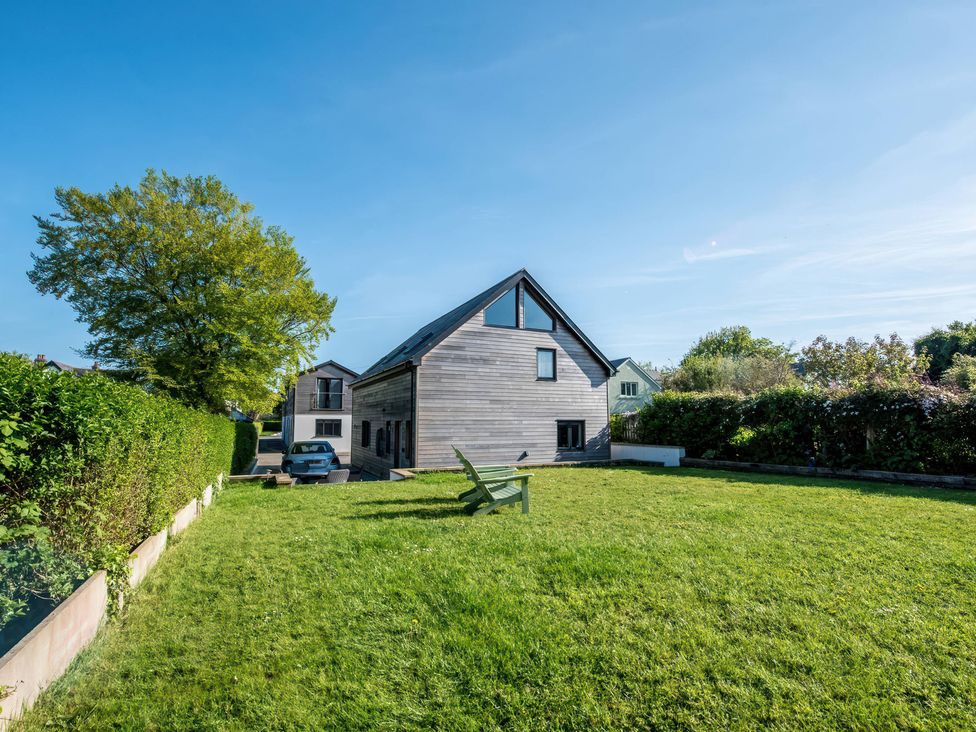 A house with lawn and trees at Sea Haze in Tenby