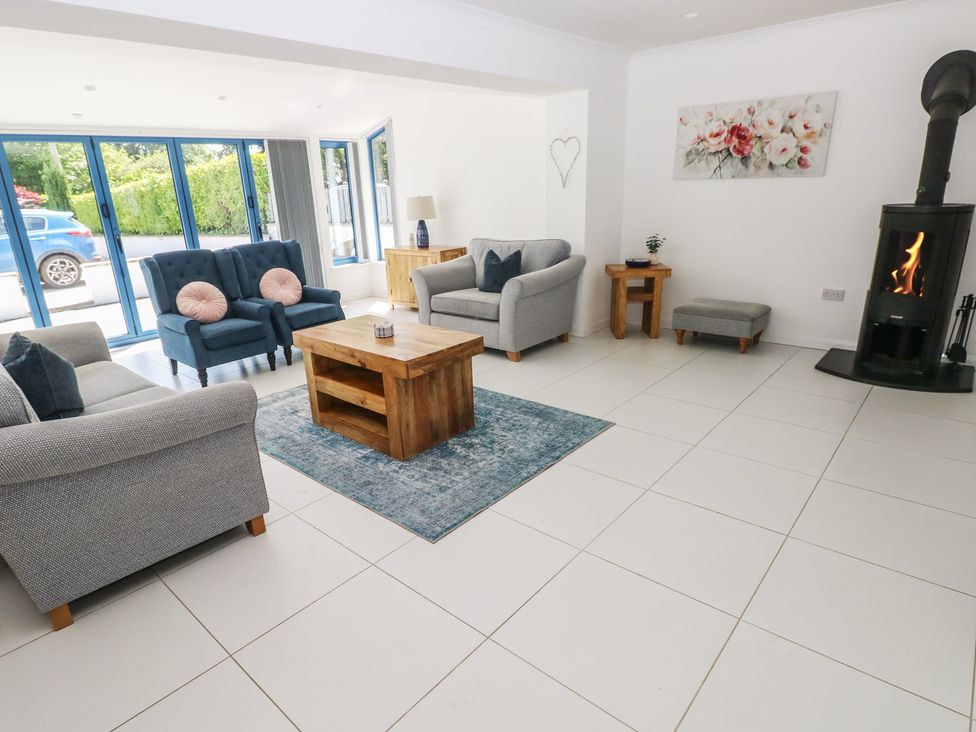 A living room with sofas and a fireplace at Sea Haze in Tenby