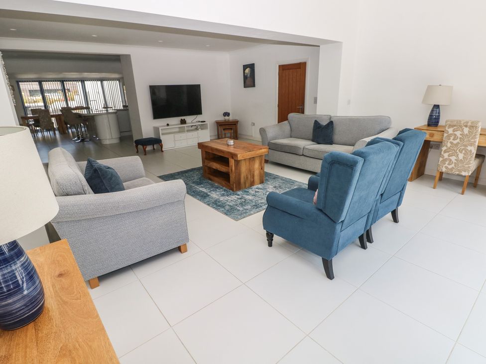 A living room with a sofa and coffee table at Sea Haze in Tenby