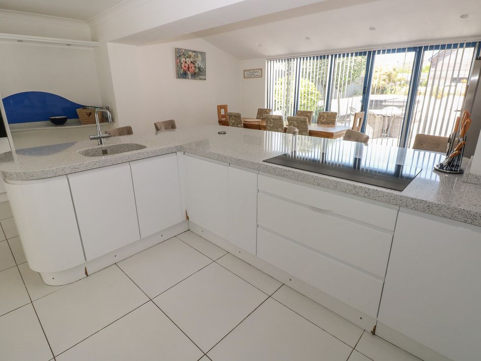 A kitchen with a countertop sink and stove at Sea Haze in Tenby
